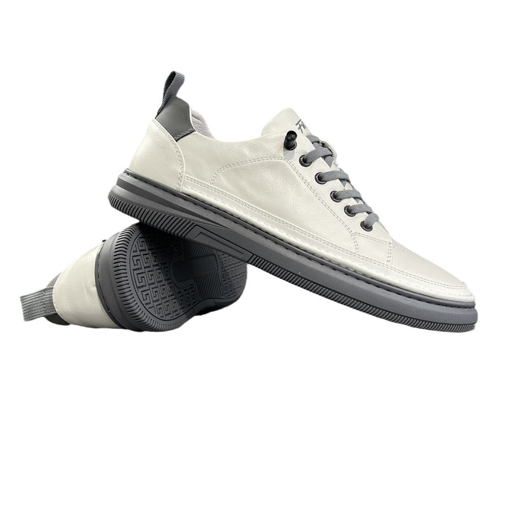 Pair of white leather low-top sneakers showing the gray outsole