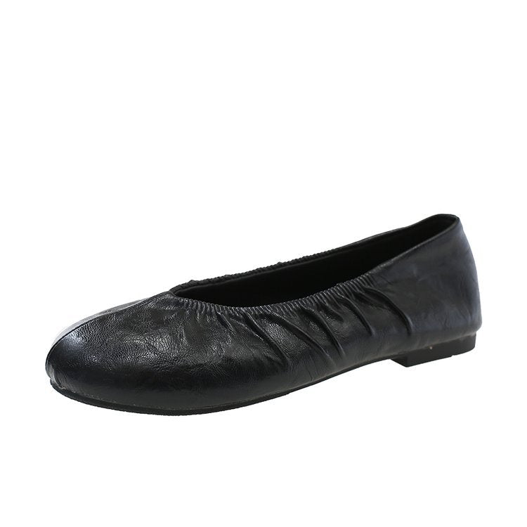 Black pleated round-toe ballet flat, side view