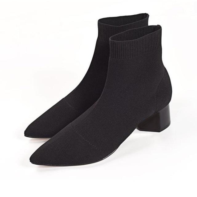 Pair of women's black pointed-toe sock ankle boots with low block heels