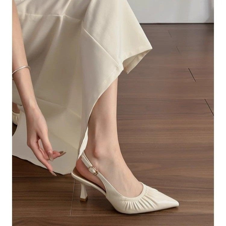 Beige ruched pointed slingback with buckle strap, side view on foot