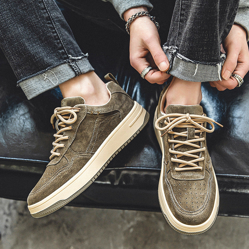 Man wearing dark brown brushed court sneakers with jeans