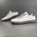 Men's white leather low-top sneakers with gray soles, smooth and perforated
