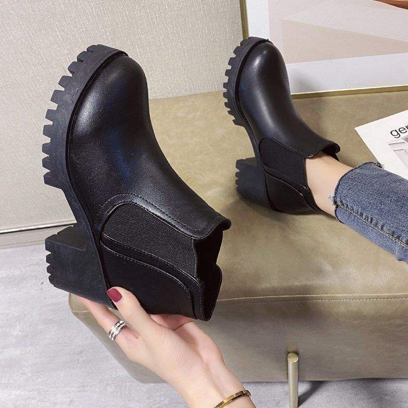 Black Chelsea ankle boot showing the elastic side panel and block heel