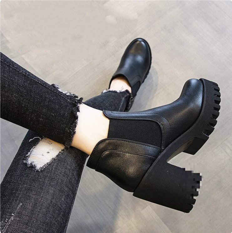 Black Chelsea ankle boots with chunky heels worn with ripped black jeans
