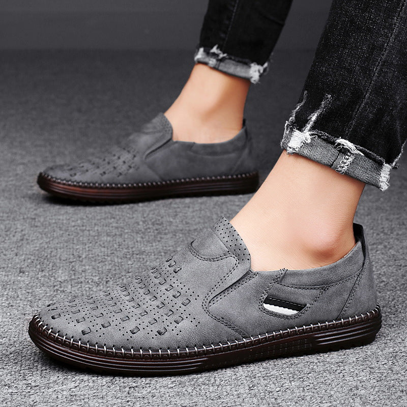 Man wearing gray perforated slip-on shoes with cuffed jeans
