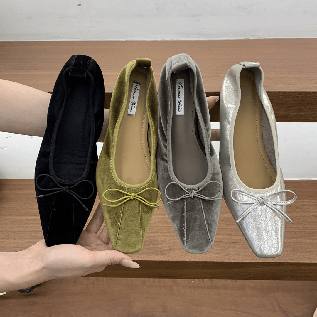Square-toe bow ballet flats in black, olive, gray and silver held side by side