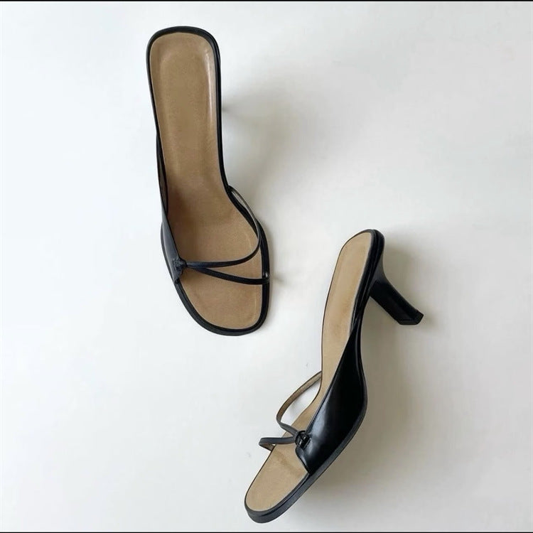 Pair of women's black strappy square-toe heeled sandals from above