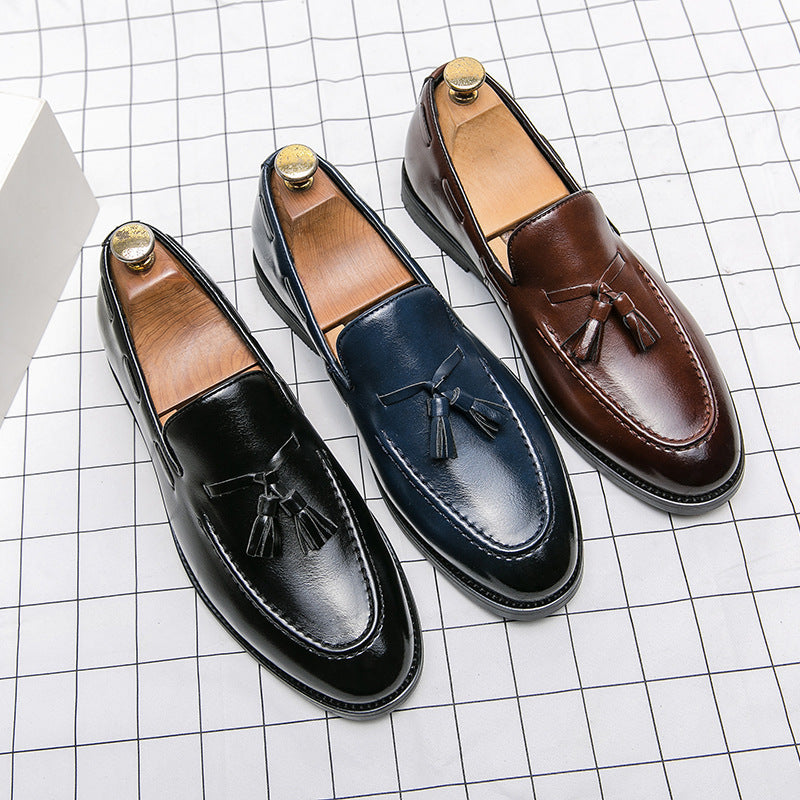 Black, navy and brown tassel loafers side by side, top view