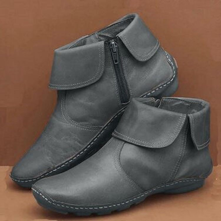 Pair of gray fold-over ankle boots with side zippers