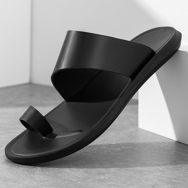 Black toe-loop slide sandal, angled view