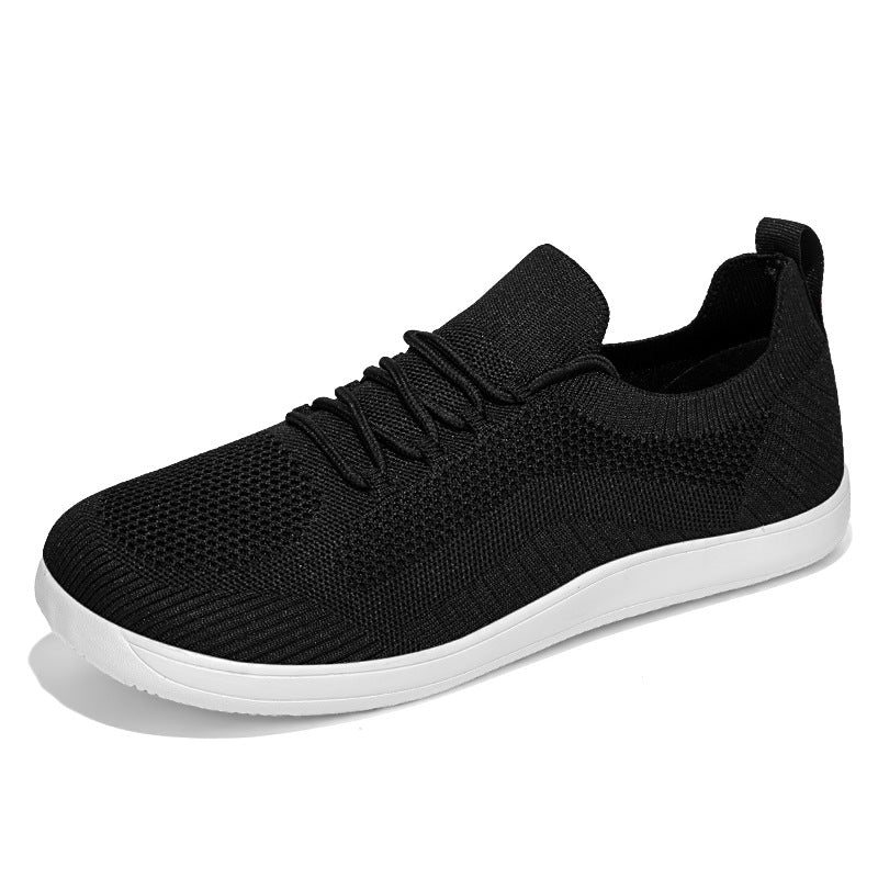 Black knit sneaker with white sole, side view