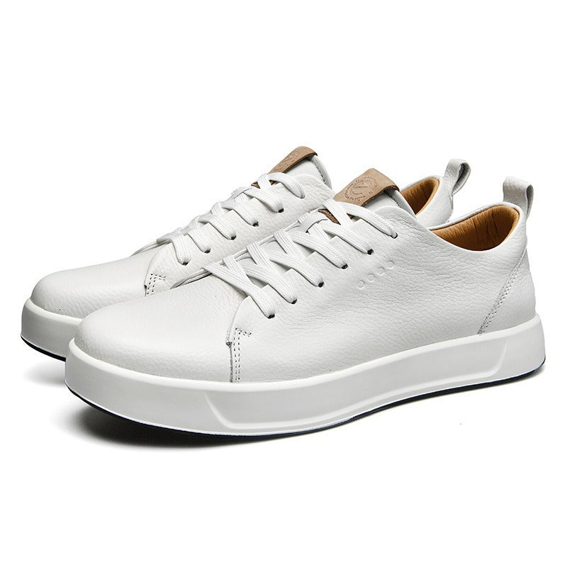 Pair of white leather low-top court sneakers, angled view