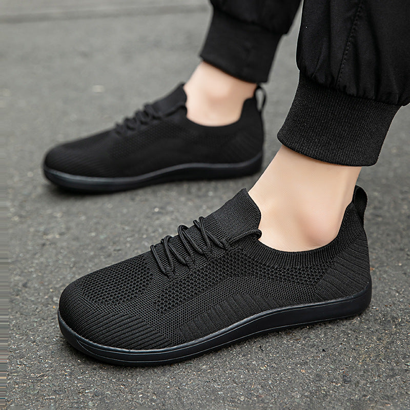 Man wearing all-black knit sneakers
