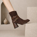 Brown suede ankle boot with double buckle strap and block heel, side view on foot