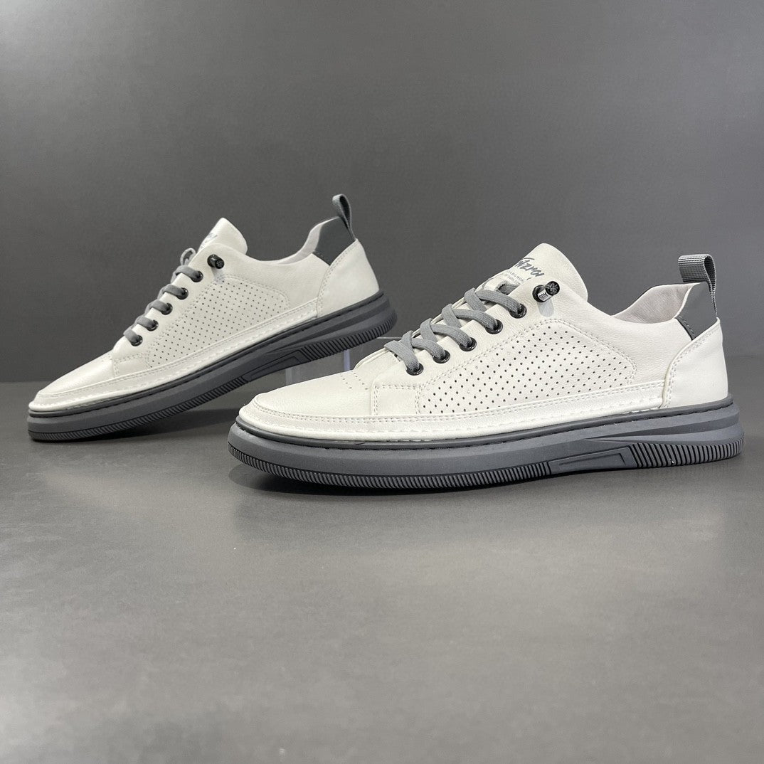 White perforated leather low-top sneaker beside a smooth white pair